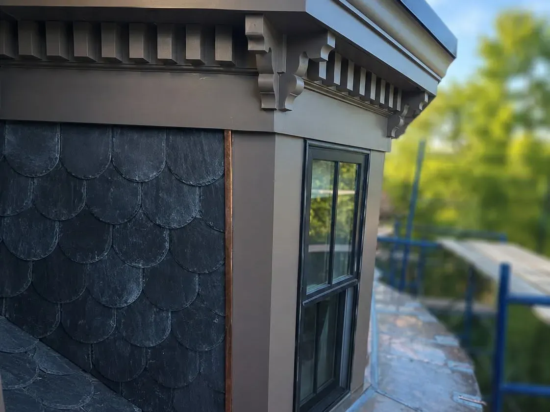 Slate mansard turret with new copper flashing and painted cornice
