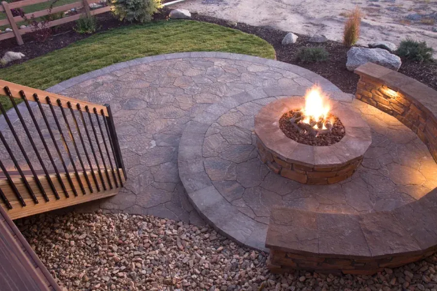 Circular stone patio built around a fire pit